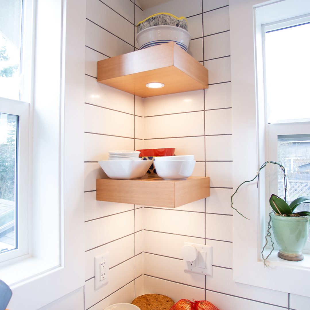 Square corner floating shelves against tile wall in kitchen