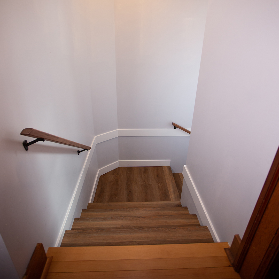 Wooden stairs leading down with small landing