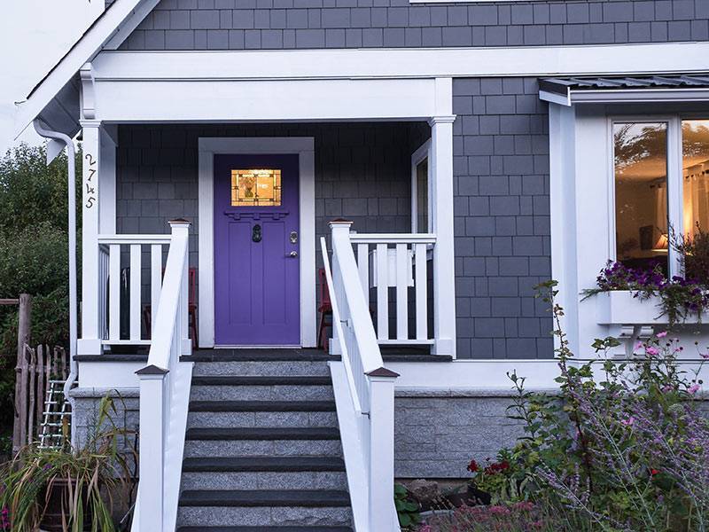 Stairs leading up to front of house with purple door