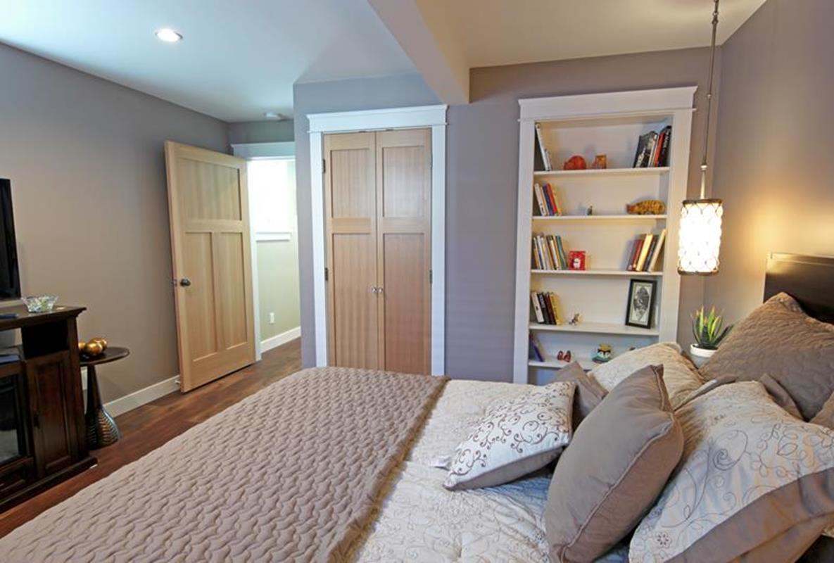 Bedroom with built-in bookshelves and hanging bedside light