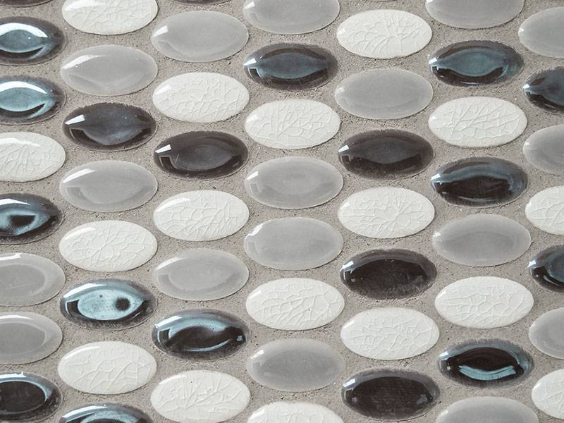 Detail of black, white, and grey small oval tiles
