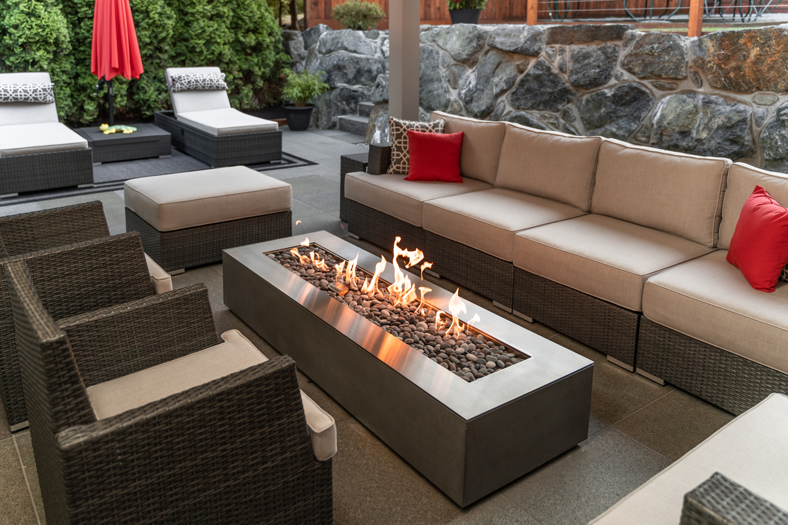 Outdoor patio with seating area and modern fire pit