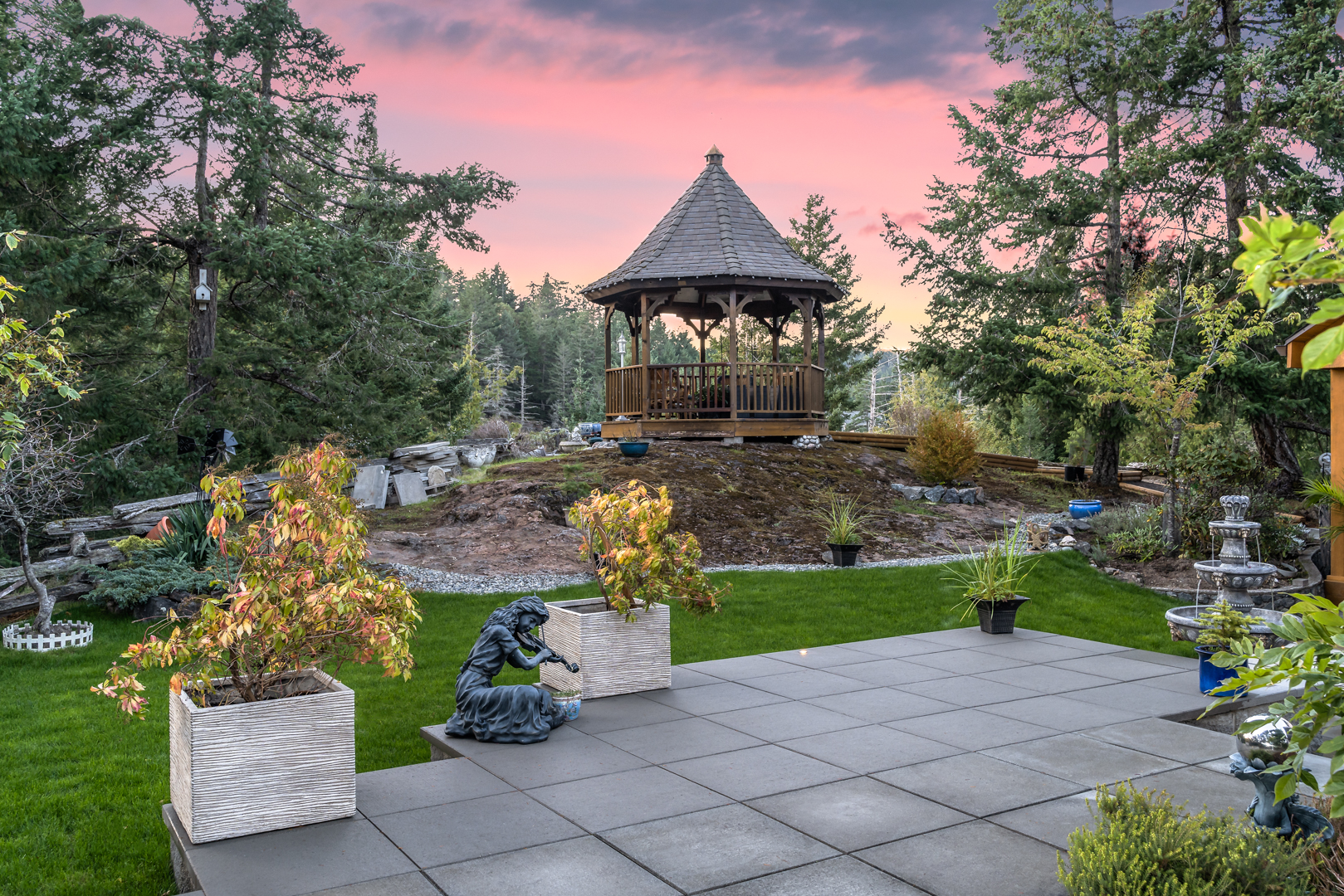 Backyard patio with gazebo perched on top of rock