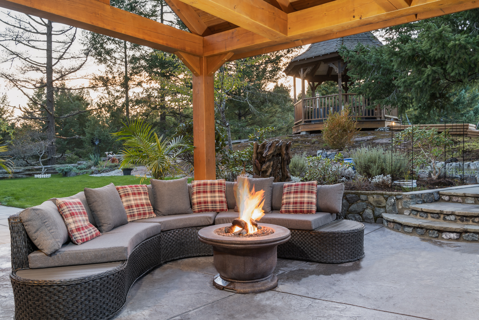 Outdoor seating area with fire pit and gazebo in background