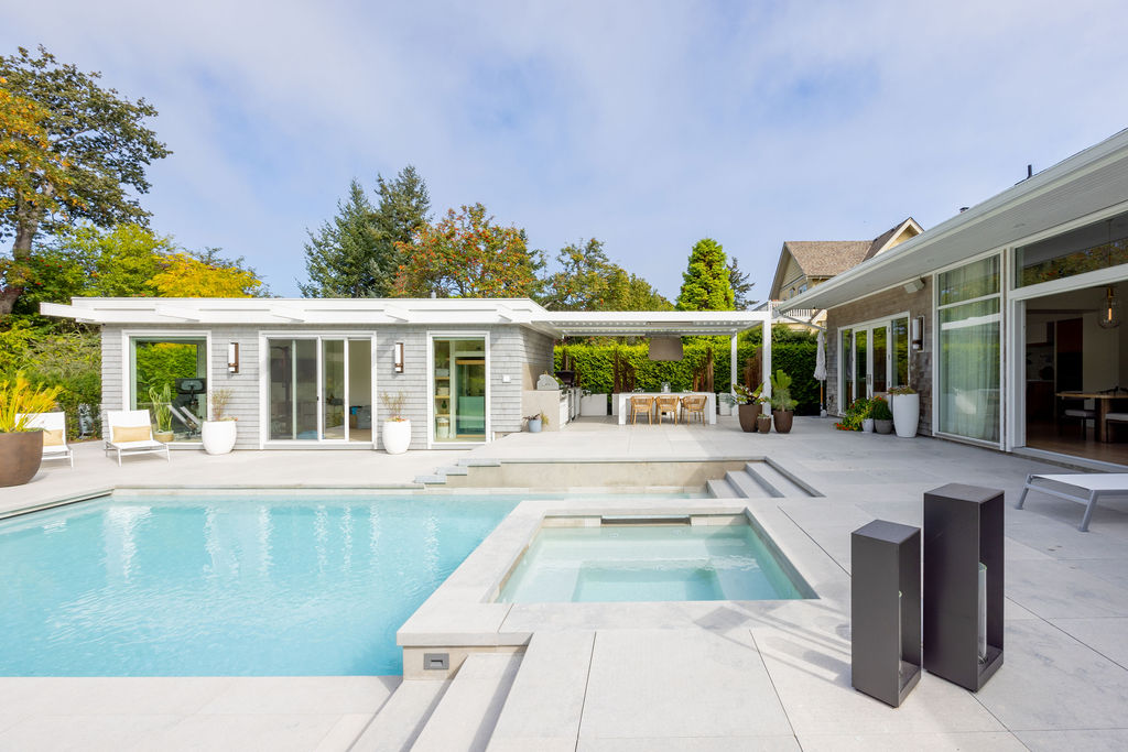 Modern outdoor pool with covered patio