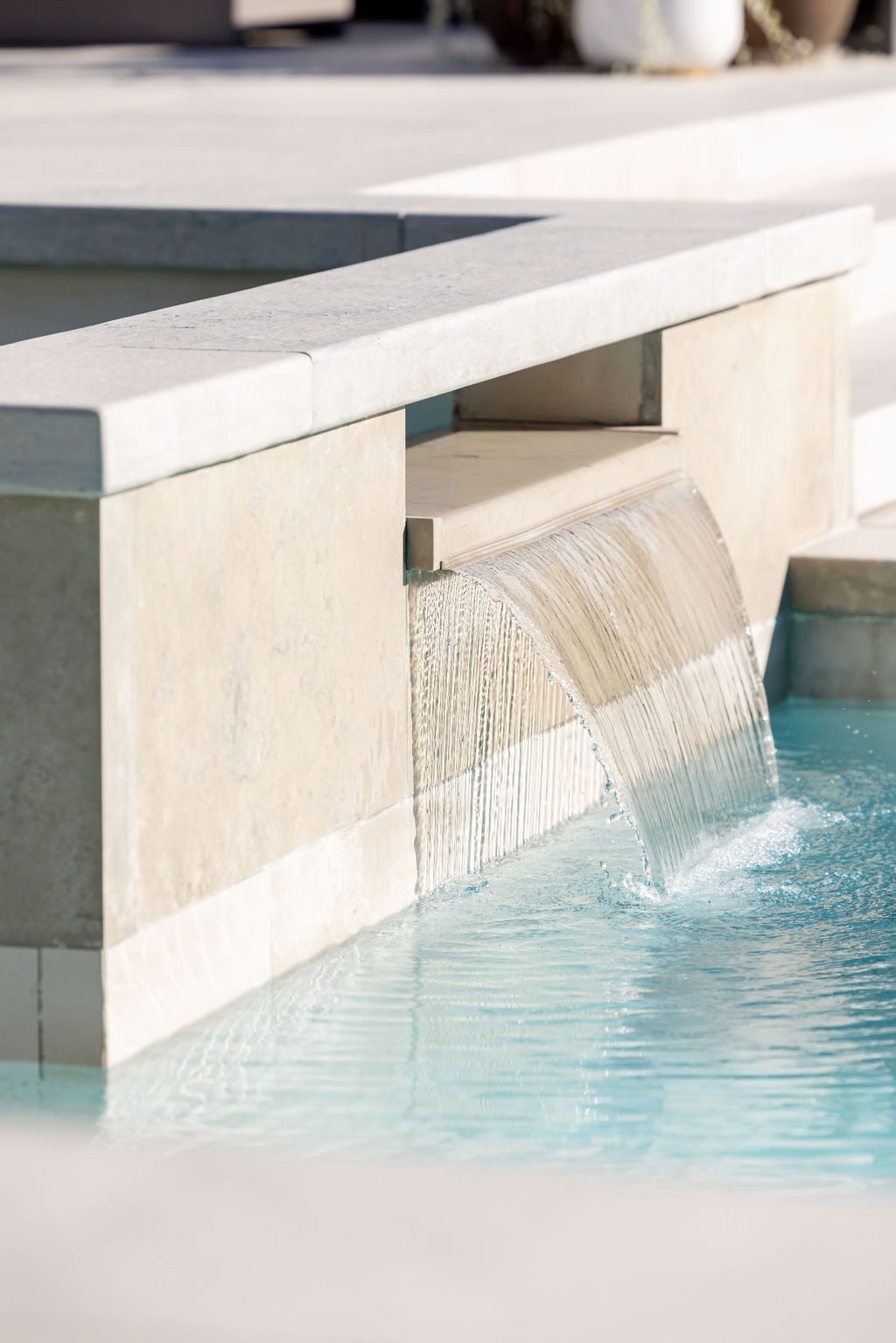 Detail of water cascading in modern outdoor pool