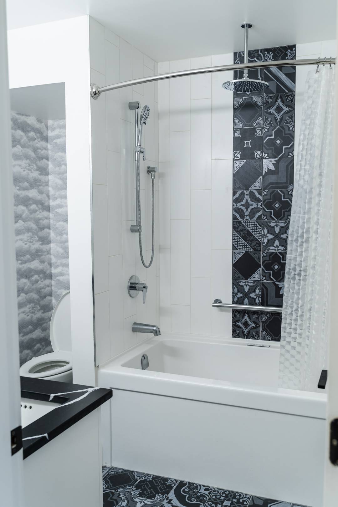 Modern bathroom with custom tile work and wallpaper