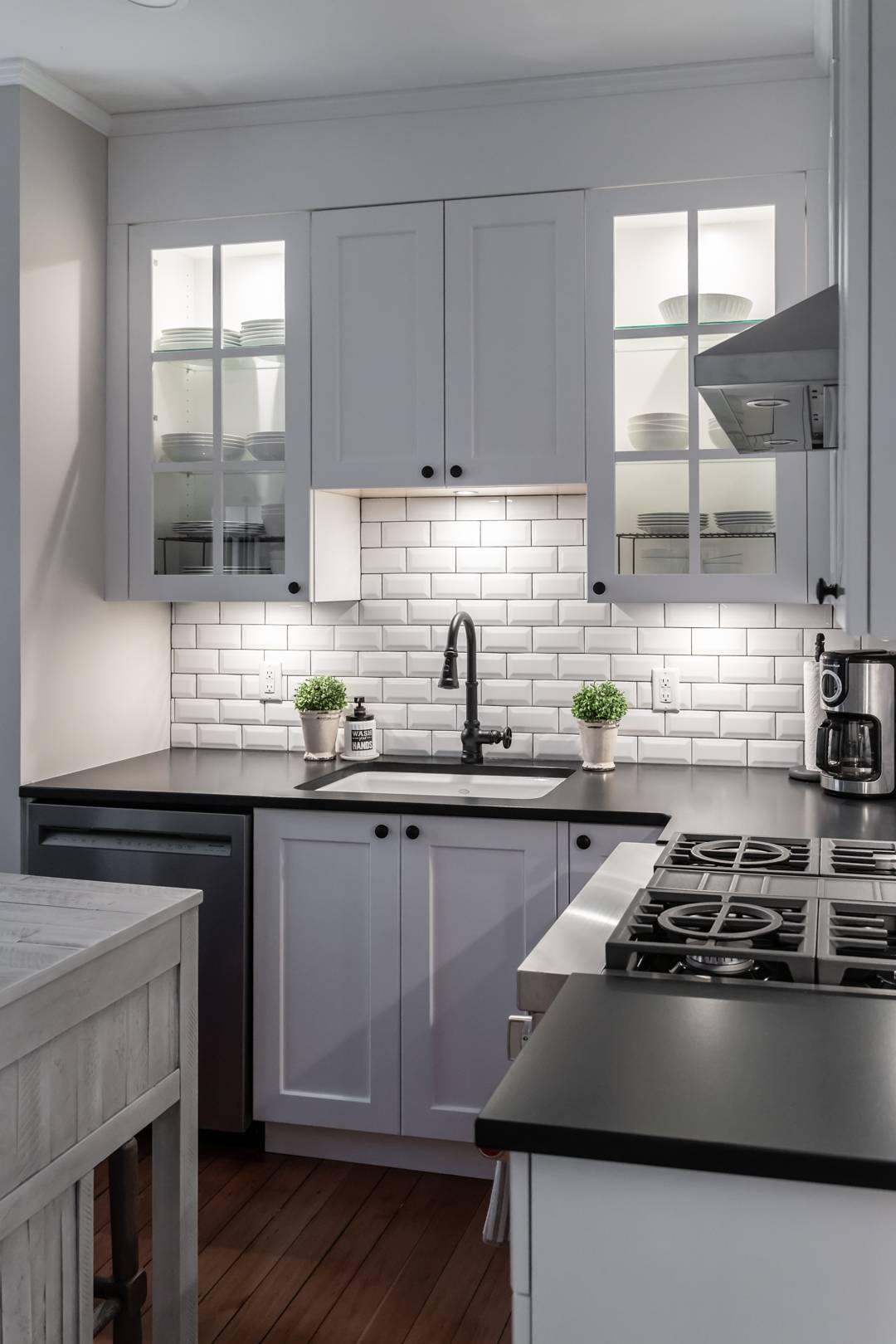 Modern kitchen with white tile backsplash and black hardware