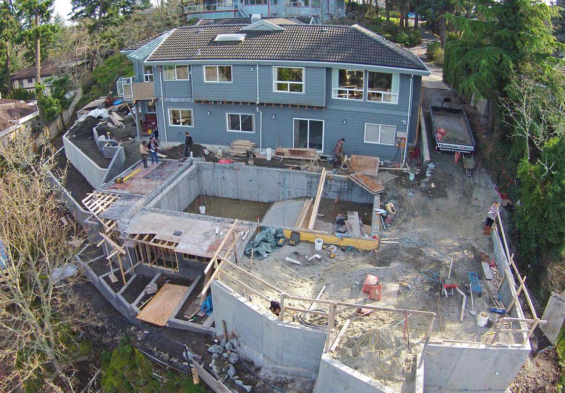 Sloping backyard of large house under construction